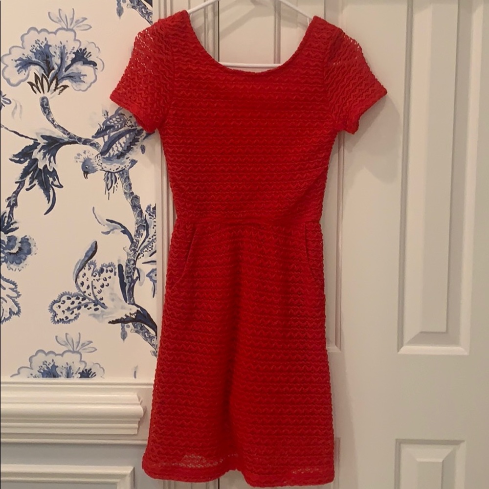Red scoop back dress with lace overlay.